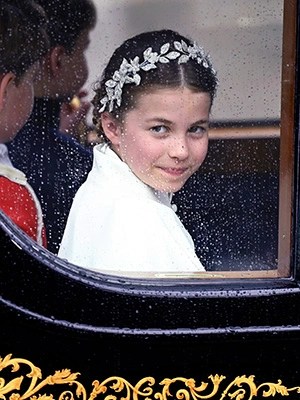 Princess Charlotte smiles from her carriage at King Charles' coronation on May 6, 2023