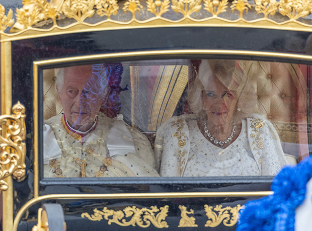 Camilla Parker Bowles smiles next to Prince Charles as they head to Westminster Abbey in their royal carriage on May 6, 2023