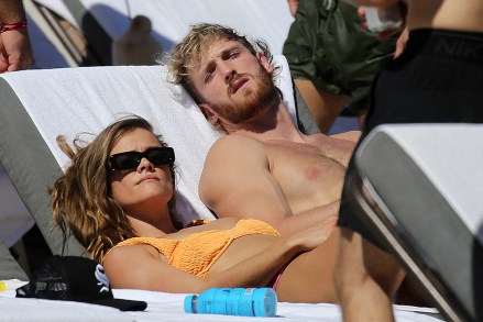 Logan Paul shows off his muscular physique as he hits the beach with bikini-clad girlfriend Nina Agdal in Miami. 23 Oct 2022 Pictured: Logan Paul; Nina Agdal. Photo credit: MEGA TheMegaAgency.com +1 888 505 6342 (Mega Agency TagID: MEGA910542_001.jpg) [Photo via Mega Agency]