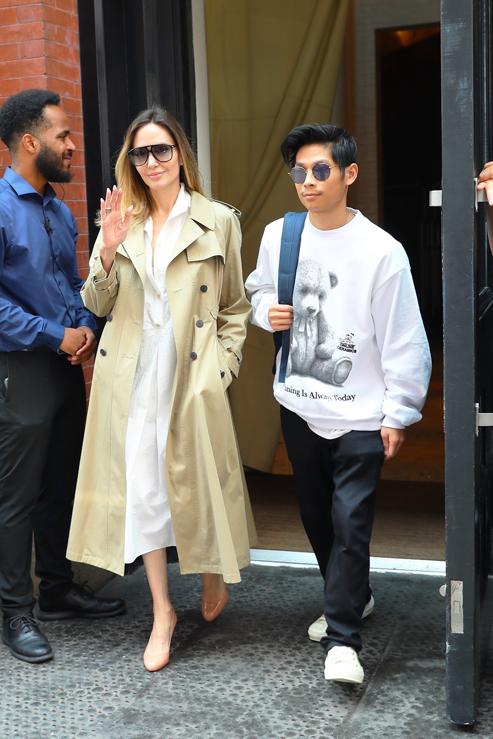 *EXCLUSIVE* Angelina Jolie and her son Pax are all smiles and wave as they check out of their hotel this afternoon in Soho