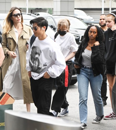 New York, NY  - *EXCLUSIVE*  - Angelina Jolie and her kids, Pax, Shiloh, Vivienne, and Zahara, were seen arriving at JFK airport in NYC. Angelina Jolie looks stylish in a white dress and a beige trench coat with an initial CD and mosquito LOGO, as her bodyguard was seen holding an Aime Leon Dore bag with a Manfrotto photography equipment box.Pictured: Angelina JolieBACKGRID USA 29 JUNE 2023 USA: +1 310 798 9111 / usasales@backgrid.comUK: +44 208 344 2007 / uksales@backgrid.com*UK Clients - Pictures Containing ChildrenPlease Pixelate Face Prior To Publication*