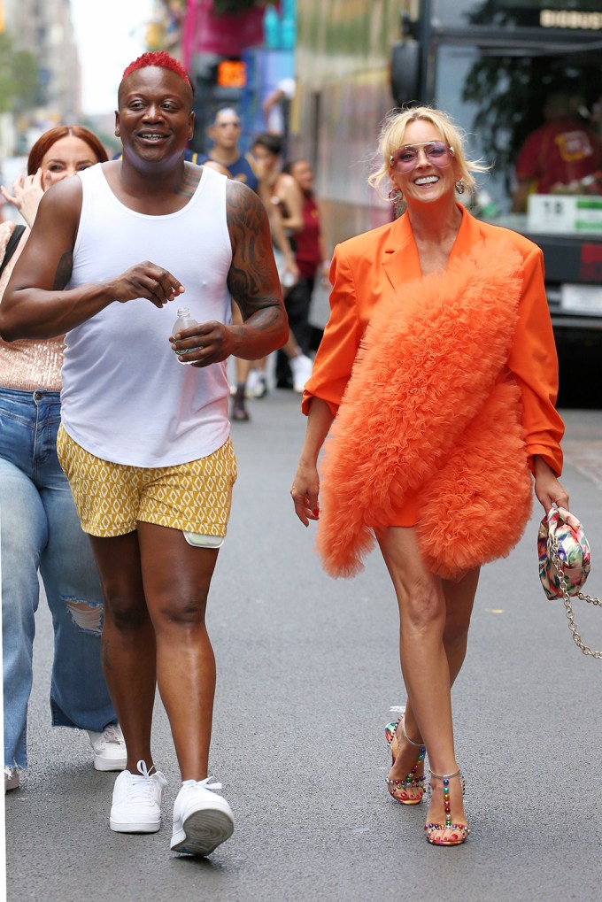 Jane Krakowski and Titus Burgess ride the Audible bus in the 2023 Pride March in New York City