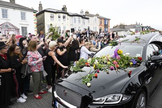 Fans gather for a 'last goodbye' to the Irish singer Sinead O'Connor as her hearse passes by her former home in Bray, Co Wicklow, Ireland, 08 August 2023. The funeral cortege passed by her old home on the way to the private burial service for the 56-years old singer, who was found dead at her home in London on 26 July 2023.
Fans gather to watch procession of Sinead O'Connor, Bray, Ireland - 08 Aug 2023