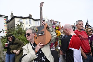 Fans gather for a 'last goodbye' to the Irish singer Sinead O'Connor outside her former home in Bray, Co Wicklow, Ireland, 08 August 2023. The funeral cortege later passed by her old home on the way to the private burial service for the 56-years old singer, who was found dead at her home in London on 26 July 2023.
Fans gather to watch procession of Sinead O'Connor, Bray, Ireland - 08 Aug 2023