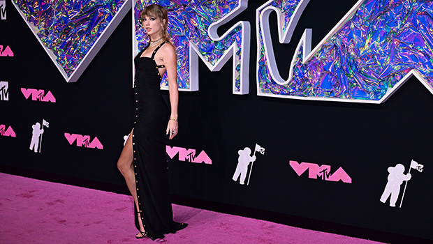 Taylor Swift arrives for the 2023 VMAs in a plunging black dress with a high slit