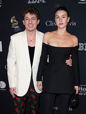 Charlie Puth Brooke Sansone posing for cameras on the red carpet