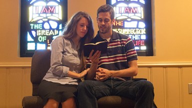 Jill Duggar and Derick Dillard reading a book