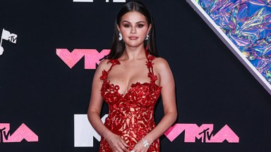 Selena Gomez posing in a red dress at the 2023 VMAs