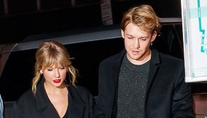 Taylor Swift and Joe Alwyn holding hands while walking