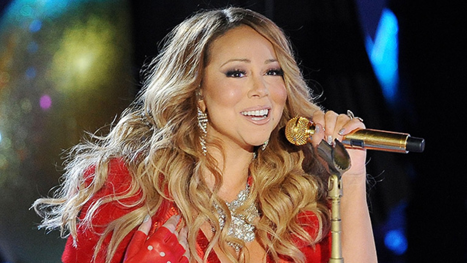 Mariah Carey steps into a hot tub in a long red sequin dress to ring in
