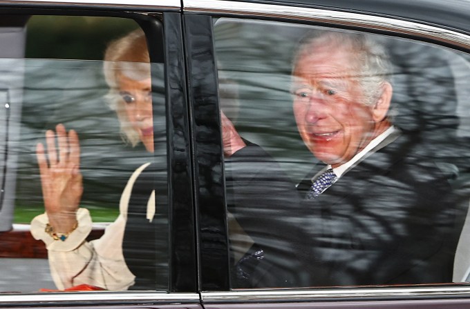 King Charles III waves to supporters