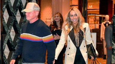 Dominic Purcell and wife Tish Cyrus holding hands