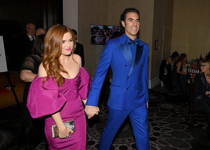 Isla Fisher holding hands with Sacha Baron Cohen