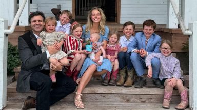 Hannah Neeleman and her family sitting on a porch