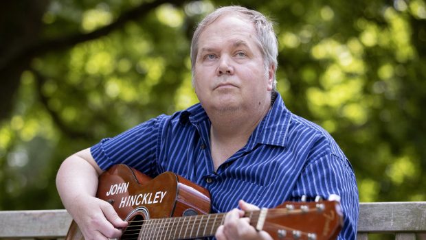 John Hinckley Jr. plays his guitar in Williamsburg, Virginia, on September 14, 2022. - More than four decades after John Hinckley shot Ronald Reagan, the man who was acquitted of the crime on an insanity defense and subsequently hospitalized for 34 years is fully free.
But the one thing he wants most after decades of treatments and years of conditional release still eludes him: a guitarist and songwriter, Hinckley longs to play a live concert. (Photo by Ryan M. Kelly / AFP) (Photo by RYAN M. KELLY/AFP via Getty Images)