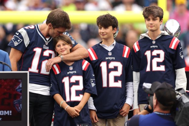  Former New England Patriots quarterback Tom Brady kisses his daughter, Vivian, while his sons, Benjamin and Jack, look on during a ceremony honoring Brady at halftime of New England's game against the Philadelphia Eagles at Gillette Stadium on September 10, 2023 in Foxborough, Massachusetts. (Photo by Maddie Meyer/Getty Images)