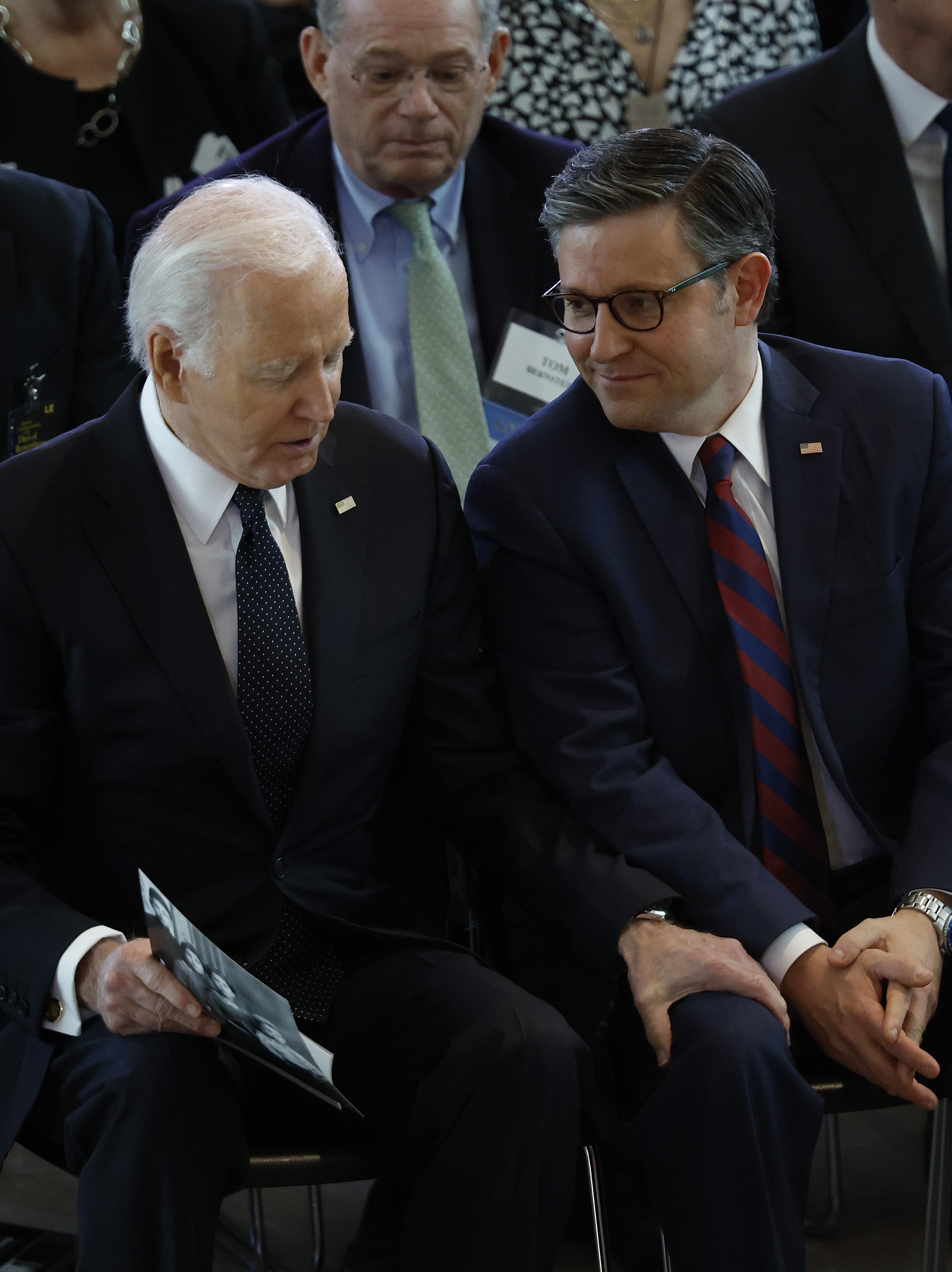 Joe Biden talks to Speaker of the House Mike Johnson