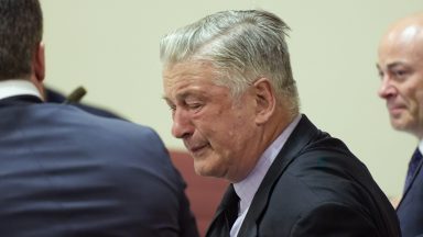 SANTA FE, NEW MEXICO - JULY 12: Alec Baldwin reacts as he sits between his attorneys Alex Spiro (L) and Luke Nikas (R) at the conclusion of his trial for involuntary manslaughter in First Judicial District Court on July 12, 2024 in Santa Fe, New Mexico. The trial for involuntary manslaughter was dismissed by a judge Friday after she ruled that key evidence over a fatal shooting on the set of "Rust" had been withheld from the defense. (Photo by Ramsay de Give-Pool/Getty Images)