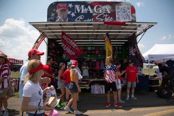 Trump supporters browse vendors before his campaign event at Butler Farm Show