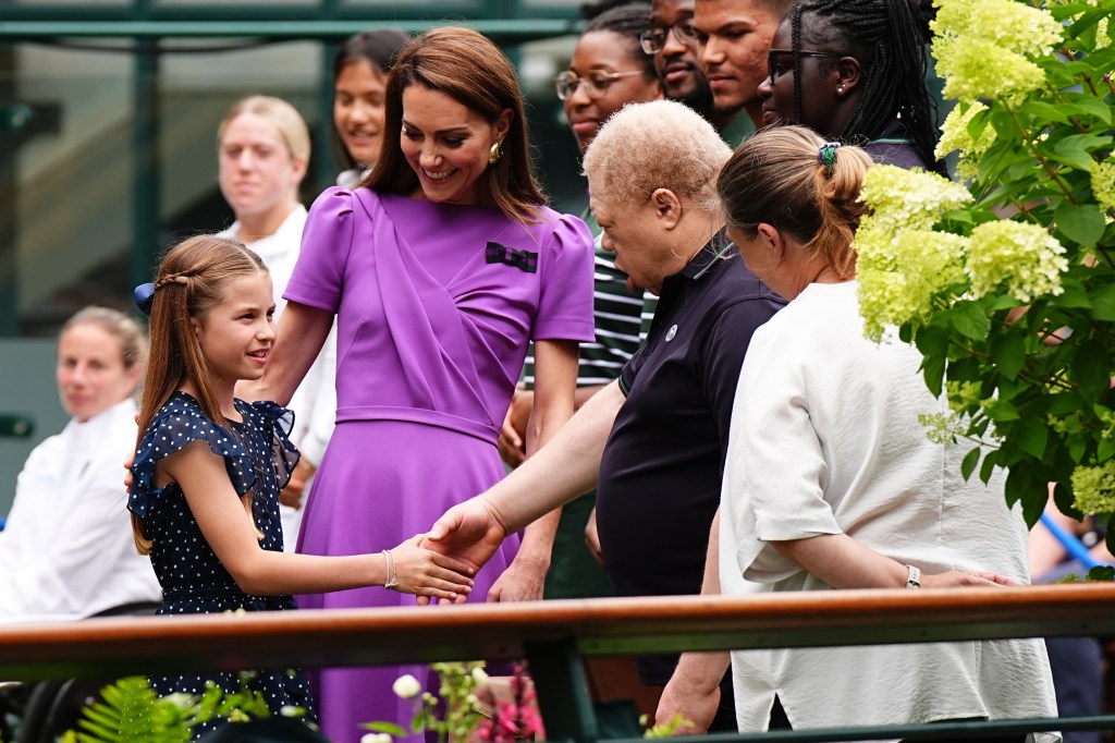 Kate Middleton and Princess Charlotte meet ground staff during a visit to the All England Lawn Tennis and Croquet Club in Wimbledon 