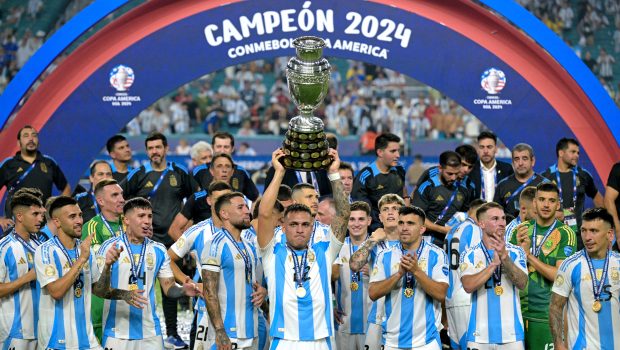 Argentina's forward #22 Lautaro Martinez lifts up the trophy as he celebrates winning the Conmebol 2024 Copa America tournament final football match between Argentina and Colombia at the Hard Rock Stadium, in Miami, Florida on July 14, 2024. (Photo by JUAN MABROMATA / AFP) (Photo by JUAN MABROMATA/AFP via Getty Images)