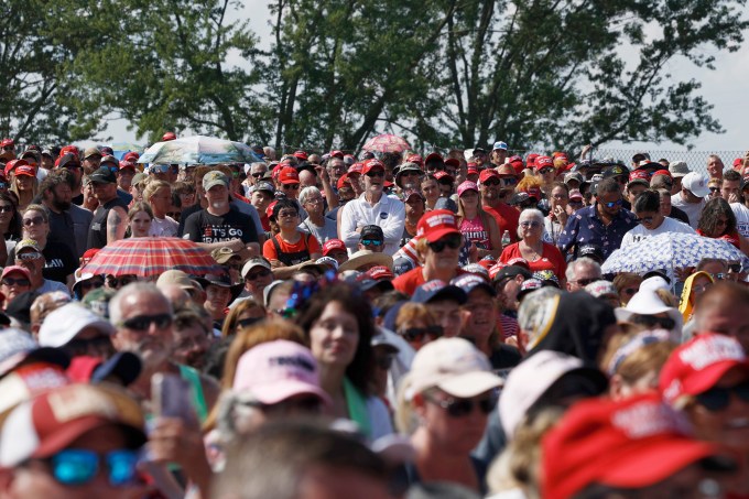 People wait for the start of Donald Trump campaign rally