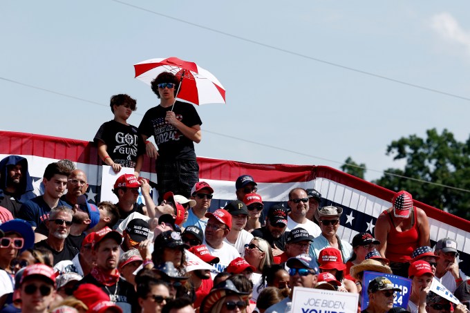 People wait for the start of Donald Trump campaign rally