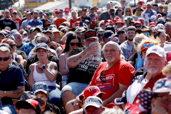 People wait for the start of Donald Trump campaign rally