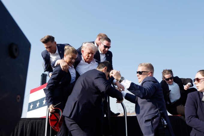 Trump is rushed offstage during a rally on July 13, 2024