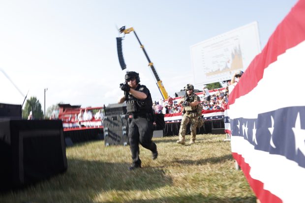  Law enforcement officers move during a rally on July 13, 2024 in Butler, Pennsylvania. Butler County district attorney Richard Goldinger said the shooter is dead after injuring former U.S. President Donald Trump, killing one audience member and injuring another in the shooting. (Photo by Anna Moneymaker/Getty Images)