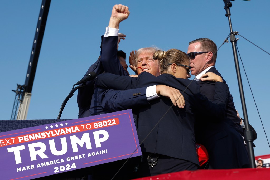 President Donald Trump pumps his fist as he is rushed offstage during a rally on July 13, 2024 in Butler, Pennsylvania. (Photo by Anna Moneymaker/Getty Images)