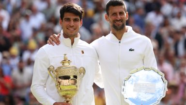 LONDON, ENGLAND - JULY 14: Carlos Alcaraz of Spain poses with the Gentlemen's Singles Trophy alongside Novak Djokovic of Serbia and his Runner-Up Trophy following the Gentlemen's Singles Final during day fourteen of The Championships Wimbledon 2024 at All England Lawn Tennis and Croquet Club on July 14, 2024 in London, England. (Photo by Clive Brunskill/Getty Images)