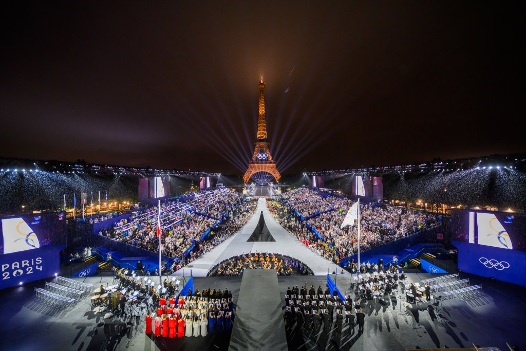 PARIS, FRANCE - JULY 26: The Olympic flag is rasied at the Place du Trocadero in front of the Eiffel Tower during the Opening Ceremony of the Olympic Games Paris 2024 on July 26, 2024 in Paris, France. (Photo by François-Xavier Marit-Pool/Getty Images)