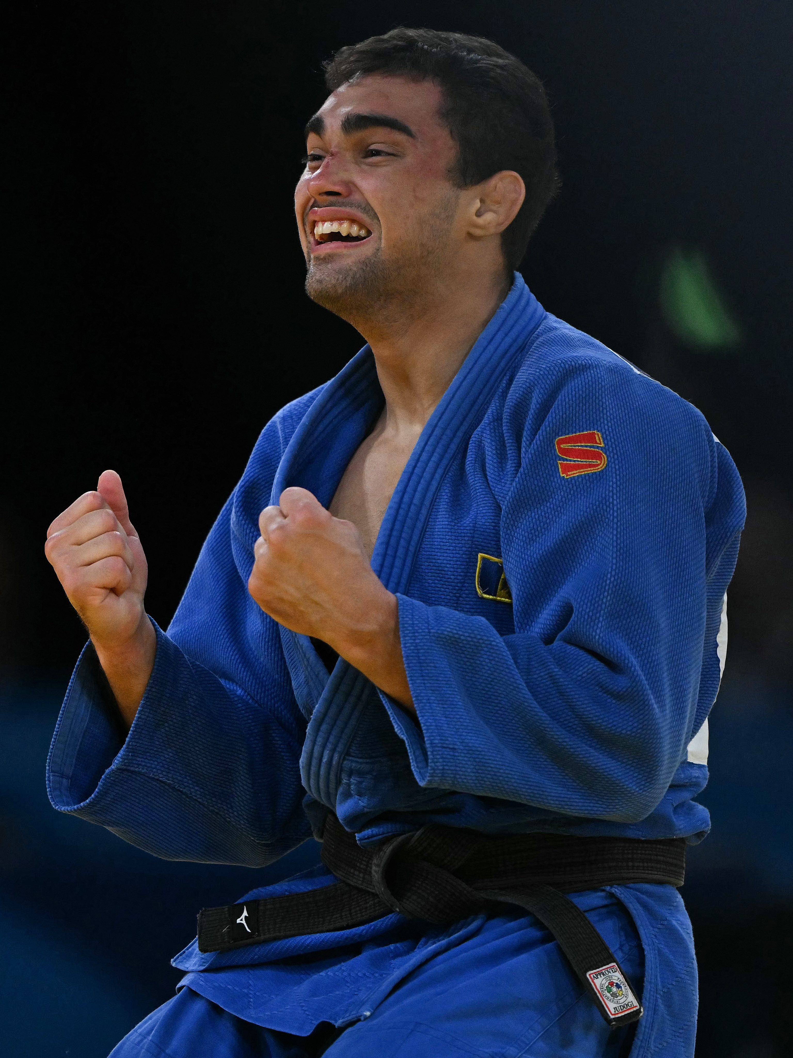 Moldova's Adil Osmanov (Blue) reacts after beating Italy's Manuel Lombardo in the judo men's -73kg bronze medal bout of the Paris 2024 Olympic Games at the Champ-de-Mars Arena, in Paris on July 29, 2024. (Photo by Luis ROBAYO / AFP) (Photo by LUIS ROBAYO/AFP via Getty Images)