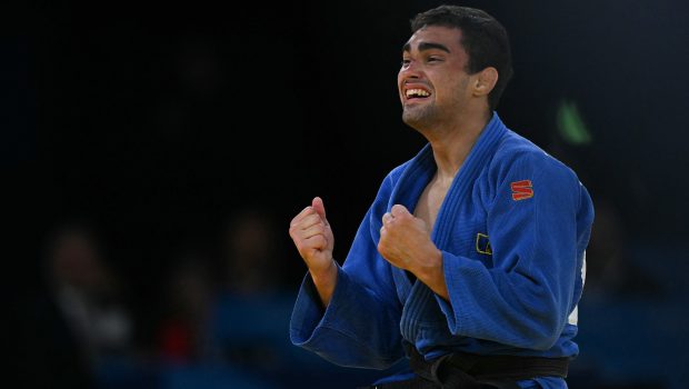 Moldova's Adil Osmanov (Blue) reacts after beating Italy's Manuel Lombardo in the judo men's -73kg bronze medal bout of the Paris 2024 Olympic Games at the Champ-de-Mars Arena, in Paris on July 29, 2024. (Photo by Luis ROBAYO / AFP) (Photo by LUIS ROBAYO/AFP via Getty Images)