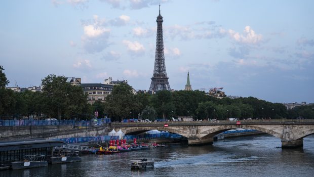 Paris, France - July 30 : A boat floats down the Seine River at sunrise after the Men's triathlon race was postponed due to Seine pollution and high E.coli levels during the 2024 Summer Olympics, at the Pont Alexandre III bridge in Paris, France, on Tuesday, July 30, 2024. (Photo by Jabin Botsford/The Washington Post via Getty Images)