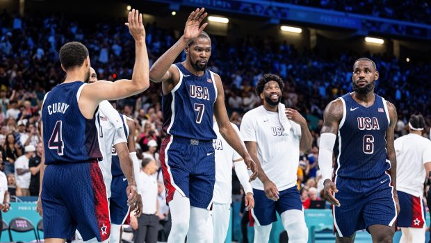 LILLE, FRANCE - JULY 28: Stephen Curry, Kevin Durant and LeBron James (L-R)  of USA celebrates victory while the group stage match between Serbia and USAon day two of the Olympic Games Paris 2024 at Stade Pierre Mauroy on July 28, 2024 in Lille, France. (Photo by Markus Gilliar - GES Sportfoto/Getty Images)