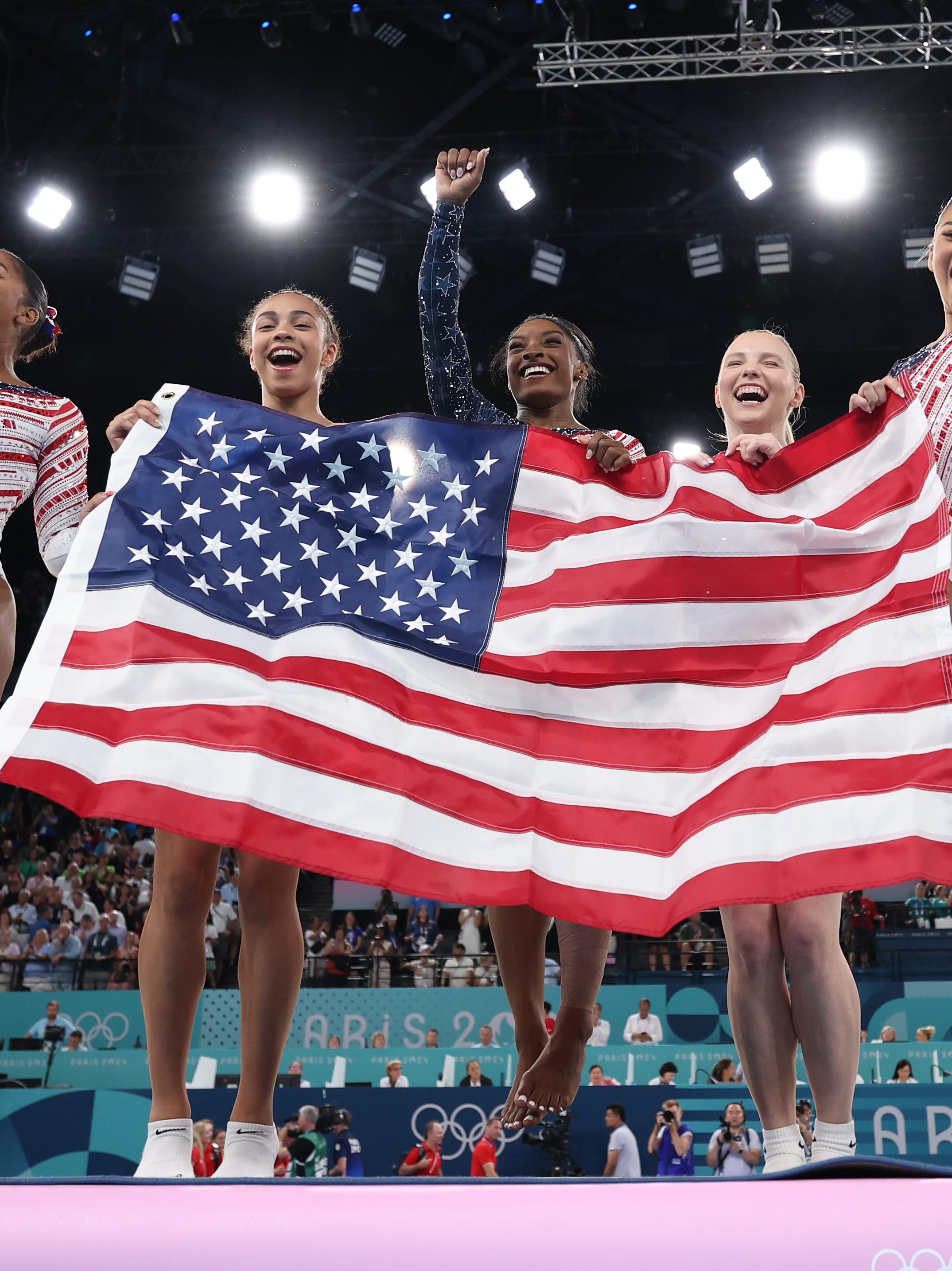 PARIS, FRANCE - JULY 30: (L-R) Jordan Chiles, Hezly Rivera,  Simone Biles, Sunisa Lee and Jade Carey of Team United States celebrate winning the gold medal during the Artistic Gymnastics Women's Team Final on day four of the Olympic Games Paris 2024 at Bercy Arena on July 30, 2024 in Paris, France. (Photo by Naomi Baker/Getty Images)
