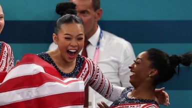 Sunisa Lee and Simone Biles of Team United States celebrate winning the gold medal