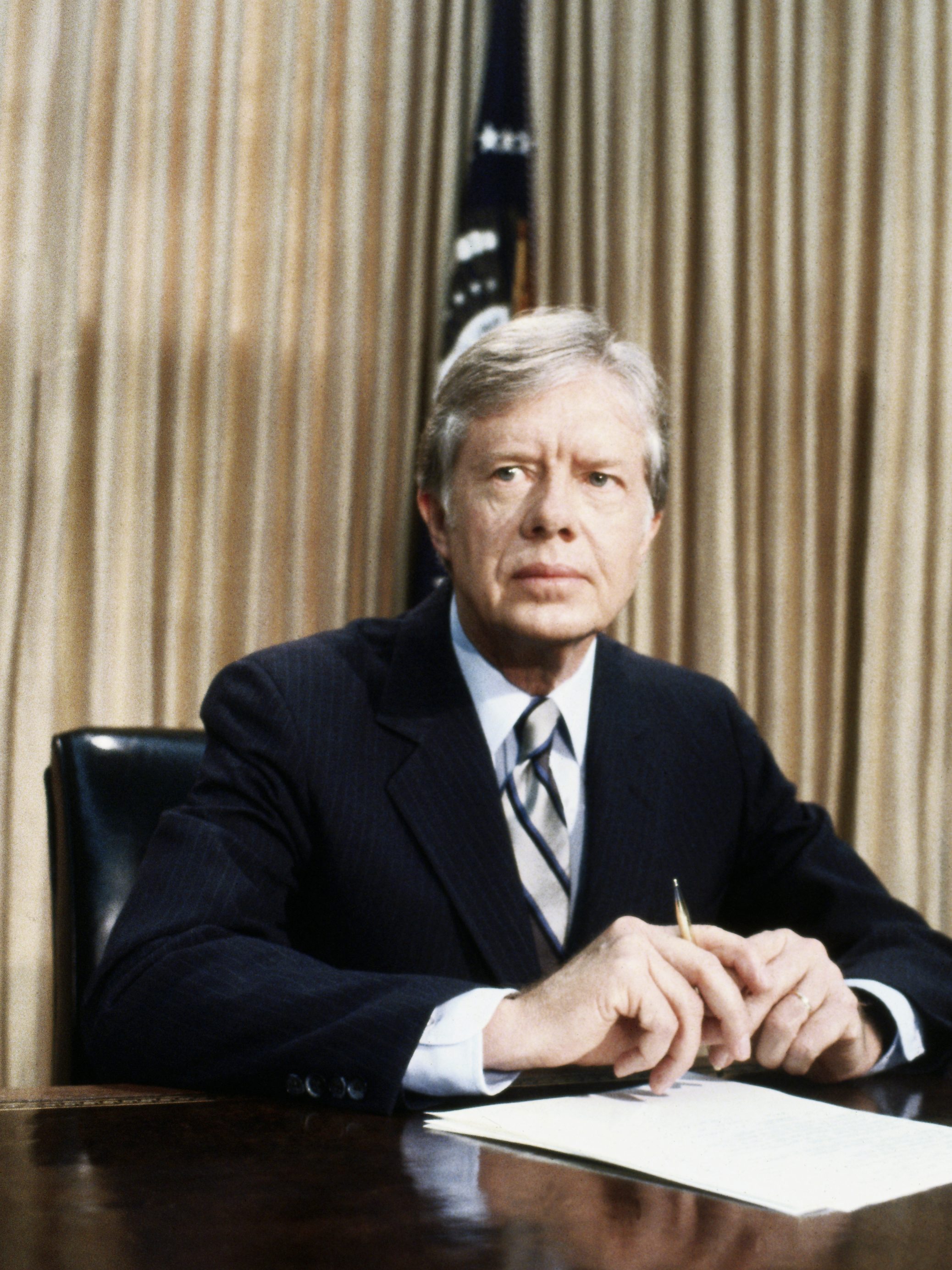 (Original Caption) 4/25/1980- Washington, DC: A grim-faced President Jimmy Carter, seated at desk in Oval Office of White House tells of the aborted rescue effort intended to get the 53 American hostages out of Iran. Carter said the mission was scrubbed after an "equipment failure" and that no military hostilities occurred.
