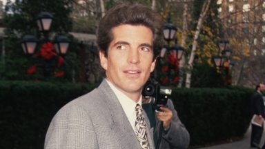 Paparazzi photographers take pictures of John F. Kennedy, Jr. on a New York City street.   (Photo by Mitchell Gerber/Corbis/VCG via Getty Images)