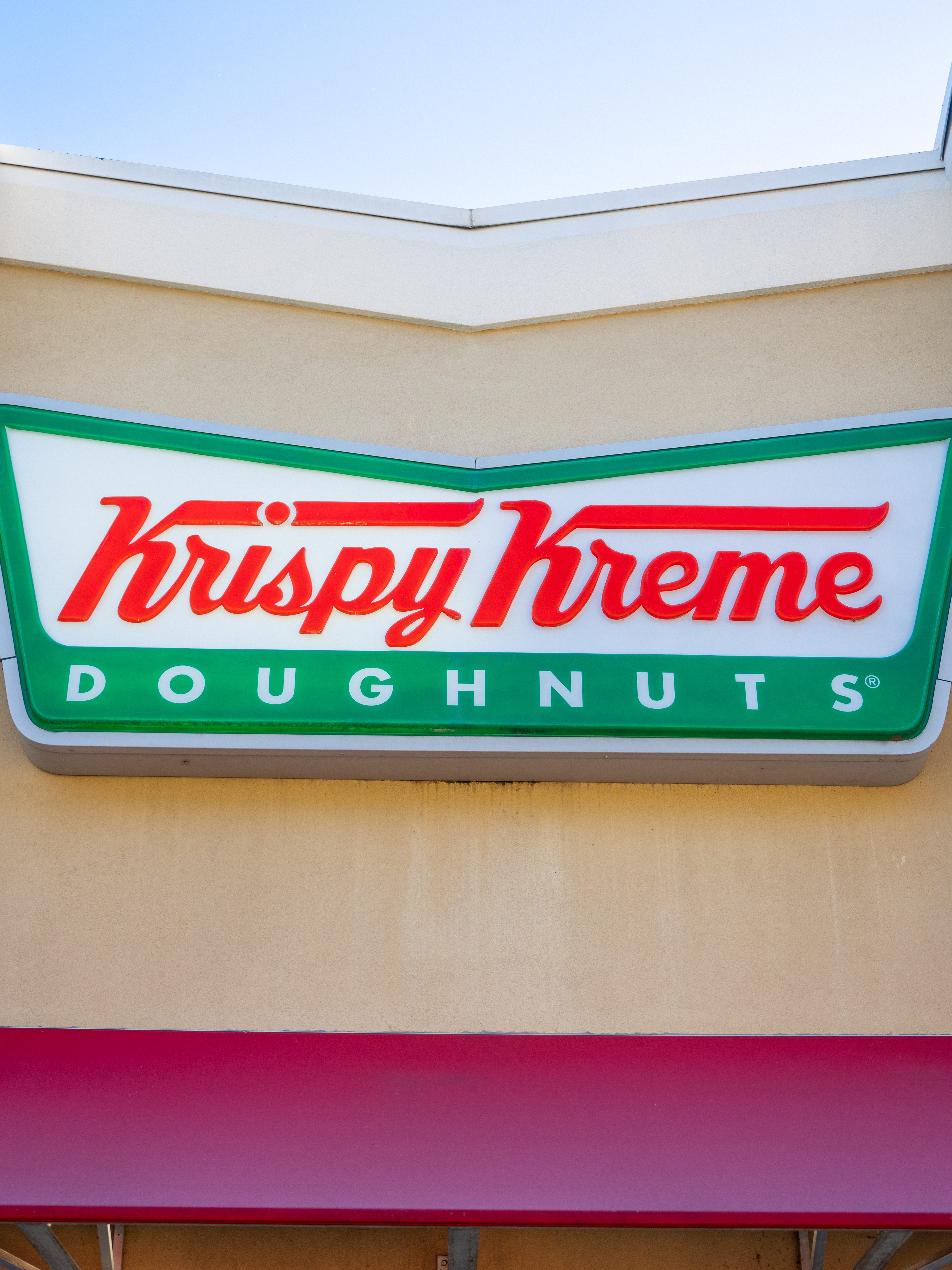 AUSTIN, TEXAS - FEBRUARY 13: The exterior of a Krispy Kreme store is seen on February 13, 2024 in Austin, Texas. Krispy Kreme Inc. today announced expected double-digit price increases in response to commodities and labor cost pressures. The Charlotte, North Carolina-based company's stock price fell by as much as 10% earlier after earnings guidance for the full year missed analysts' estimates.  (Photo by Brandon Bell/Getty Images)