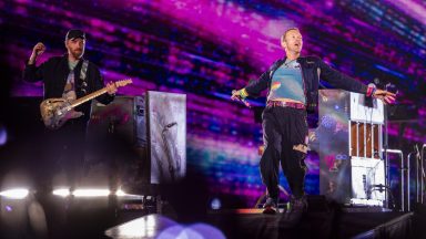 ROME, ITALY - JULY 12: (EDITORIAL USE ONLY) Jonny Buckland (L) and Chris Martin (R) of the group Coldplay Performs at Stadio Olimpico on July 12, 2024 in Rome, Italy. (Photo by Roberto Panucci - Corbis/Corbis via Getty Images)