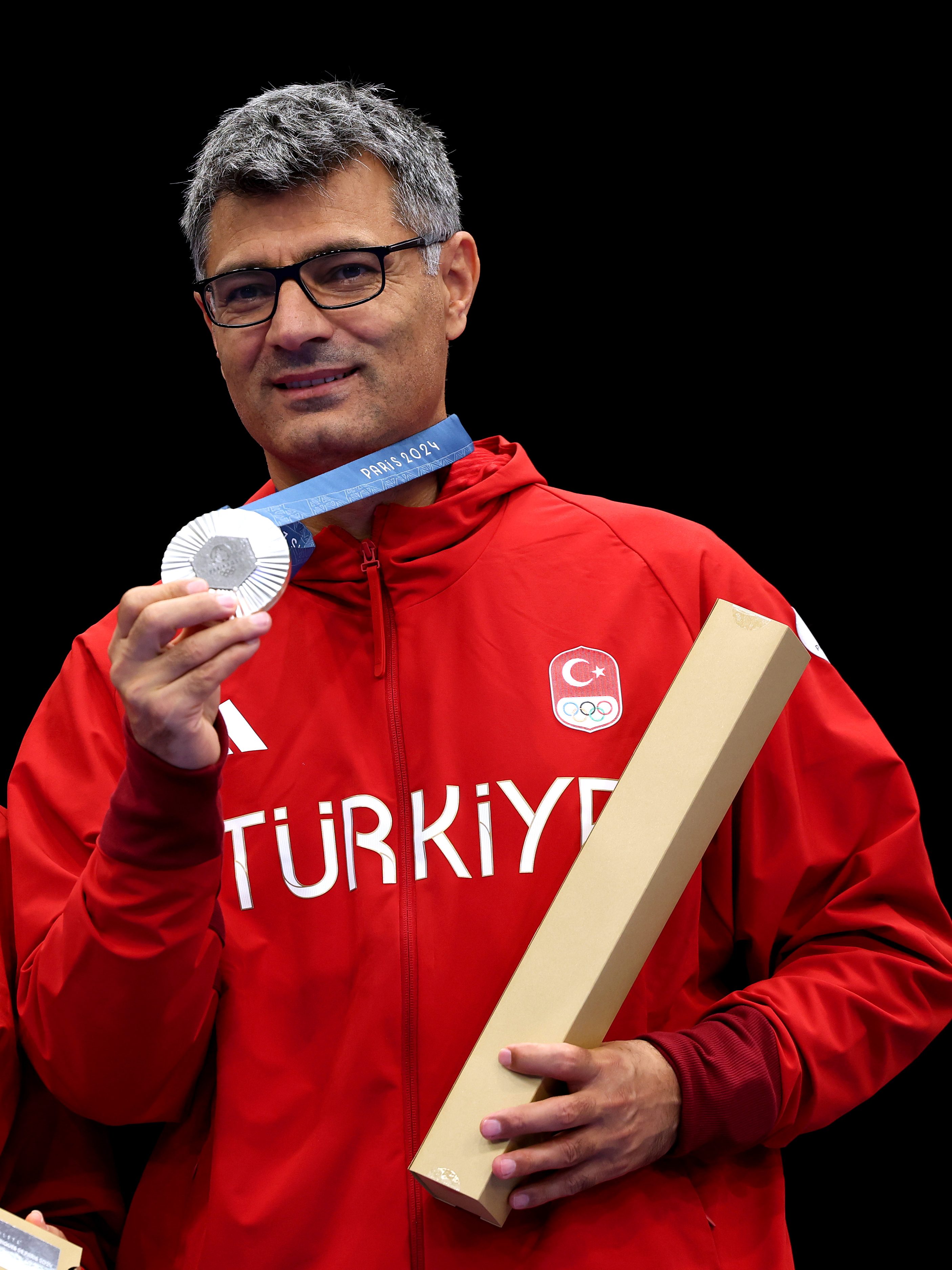CHATEAUROUX, FRANCE - JULY 30: Silver medalists Sevval Ilayda Tarhan and Yusuf Dikec of Team Turkiye pose on the podium during the Shooting 10m Air Pistol Mixed Team medal ceremony on day four of the Olympic Games Paris 2024 at Chateauroux Shooting Centre on July 30, 2024 in Chateauroux, France. (Photo by Charles McQuillan/Getty Images)
