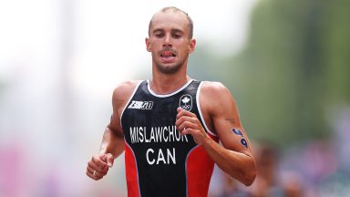 PARIS, FRANCE - JULY 31: Tyler Mislawchuk of Team Canada competes during Men's Individual Triathlon on day five of the Olympic Games Paris 2024 at Pont Alexandre III on July 31, 2024 in Paris, France. (Photo by Lars Baron/Getty Images)