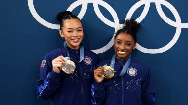 PARIS, FRANCE - AUGUST 01: (L-R) Bronze medalist Sunisa Lee and Gold medalist Simone Biles of Team United States pose with the Olympic Rings during the Artistic Gymnastics Women's All-Around Final medal ceremony on day six of the Olympic Games Paris 2024 at Bercy Arena on August 01, 2024 in Paris, France. (Photo by Jamie Squire/Getty Images)