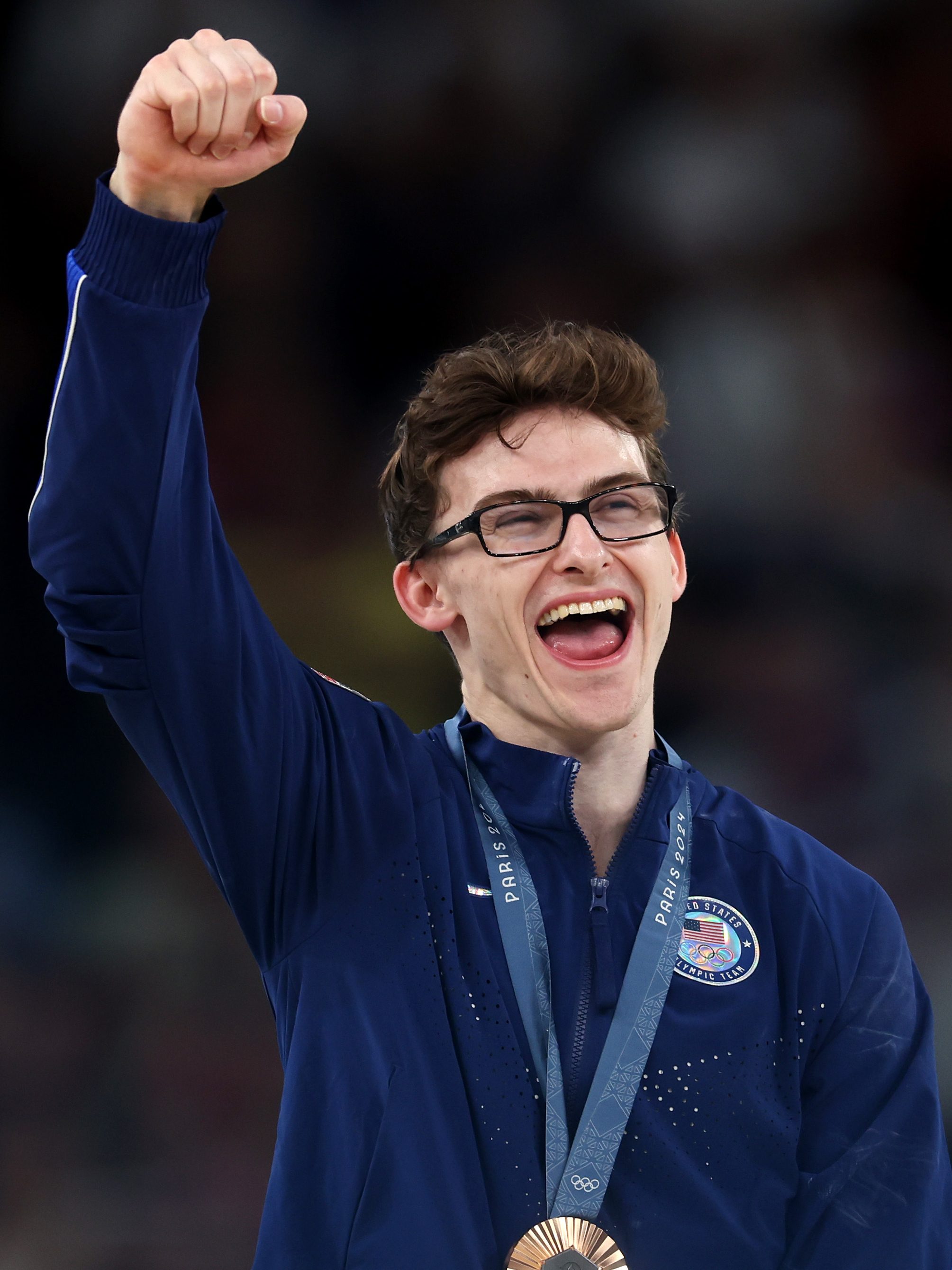 PARIS, FRANCE - AUGUST 03: Bronze medalist Stephen Nedoroscik of Team United States celebrates on the podium during the medal ceremony for the Artistic Gymnastics Men's Pommel Horse Final on day eight of the Olympic Games Paris 2024 at Bercy Arena on August 03, 2024 in Paris, France. (Photo by Julian Finney/Getty Images)