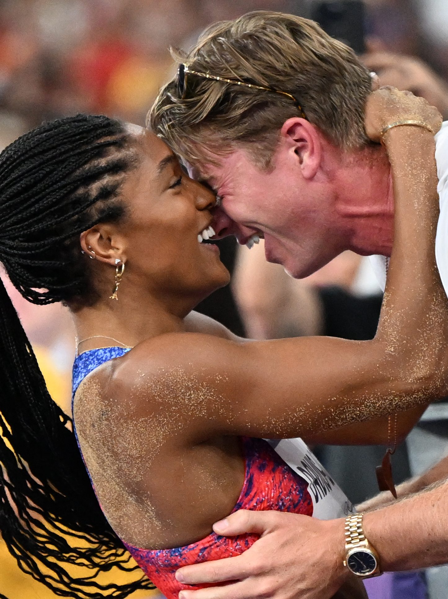 Gold medallist US' Tara Davis-Woodhall (L) celebrates with her husband US' track and field paralympic athlete Hunter Woodhall (R) after winning the women's long jump final of the athletics event at the Paris 2024 Olympic Games at Stade de France in Saint-Denis, north of Paris, on August 8, 2024. (Photo by Kirill KUDRYAVTSEV / AFP) (Photo by KIRILL KUDRYAVTSEV/AFP via Getty Images)