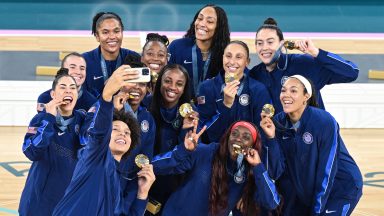 Gold medallists USA pose during the podium ceremony after the women's Gold Medal basketball match between France and the USA during the Paris 2024 Olympic Games at the Bercy  Arena in Paris on August 11, 2024. (Photo by Damien MEYER / AFP) (Photo by DAMIEN MEYER/AFP via Getty Images)