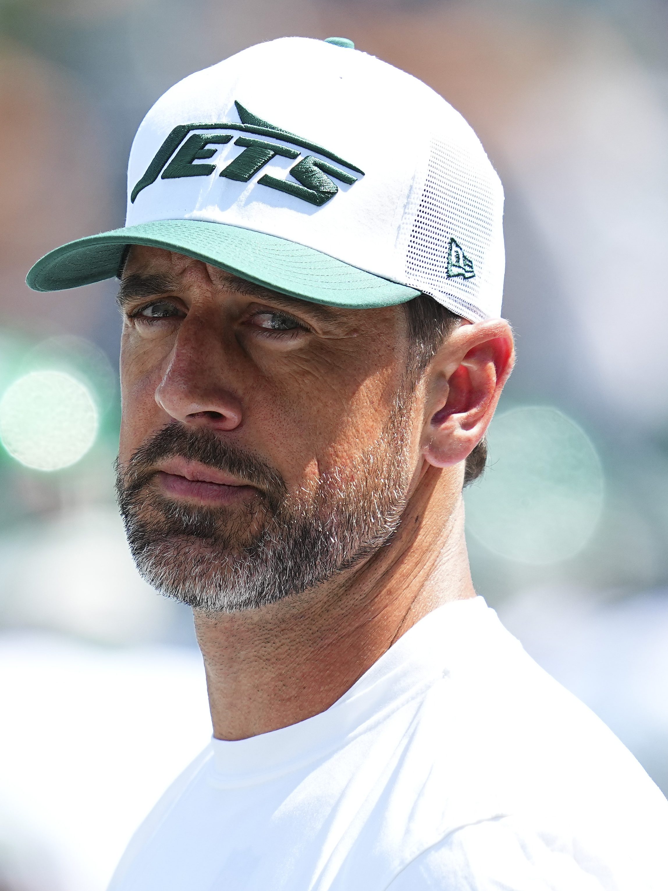 EAST RUTHERFORD, NEW JERSEY - AUGUST 10: Aaron Rodgers #8 of the New York Jets looks on against the Washington Commanders during the preseason game at MetLife Stadium on August 10, 2024 in East Rutherford, New Jersey. The Jets defeated the Commanders 20-17. (Photo by Mitchell Leff/Getty Images)